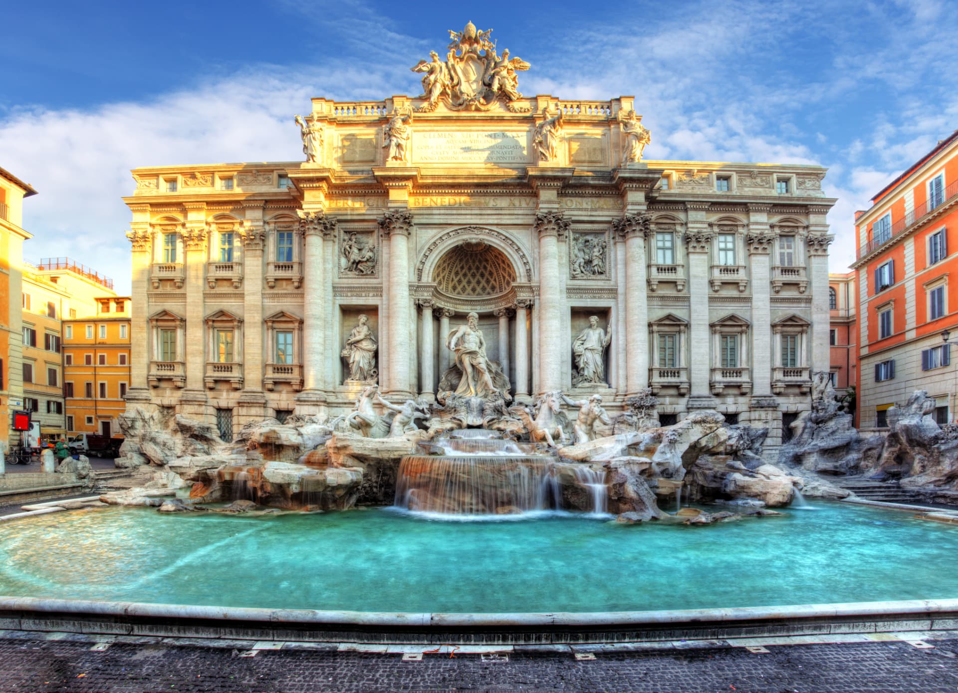 The Trevi Fountain in Rome at sunrise with turquoise water