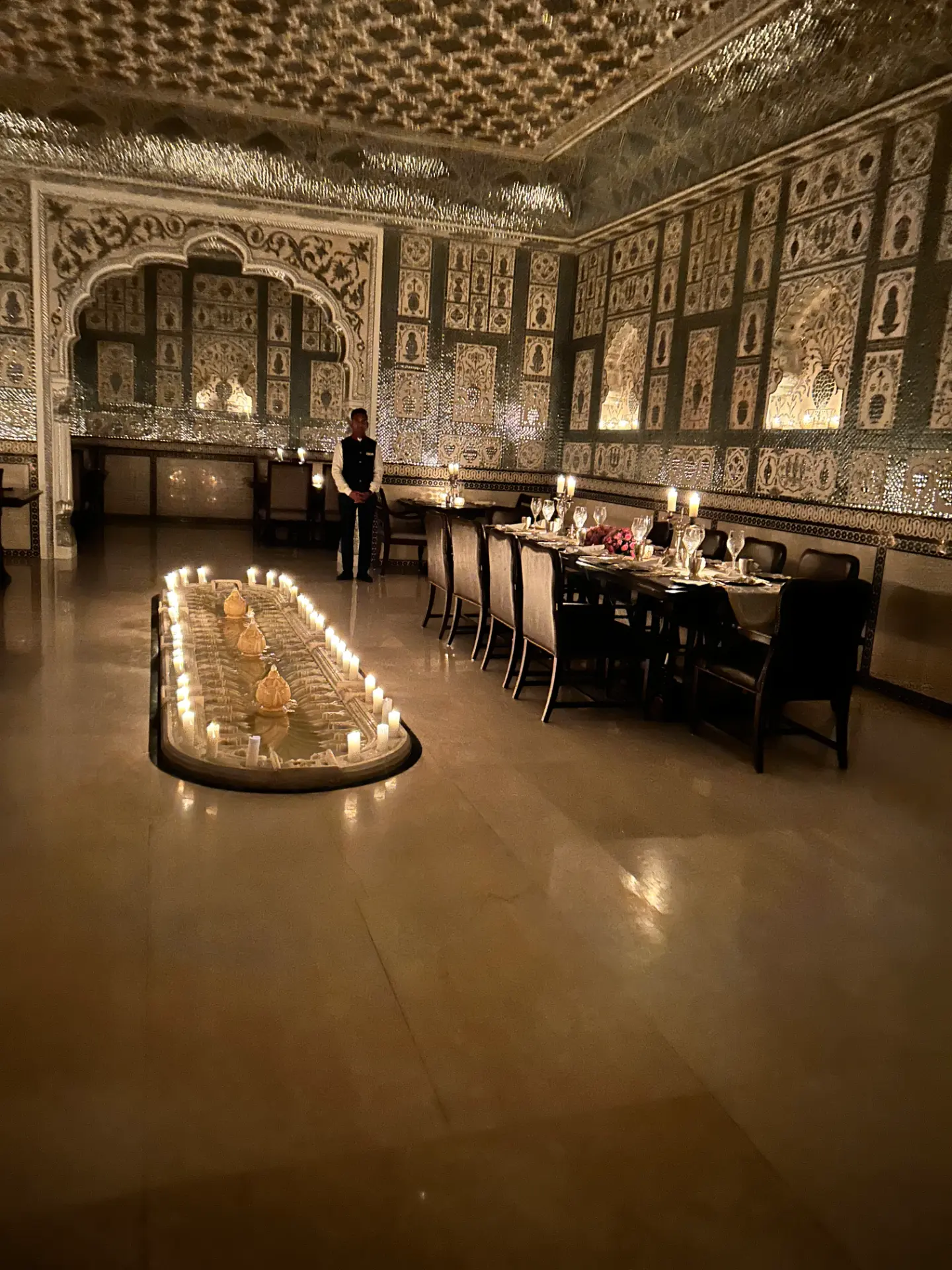 Candlelit private dining in a mirrored palace hall in India