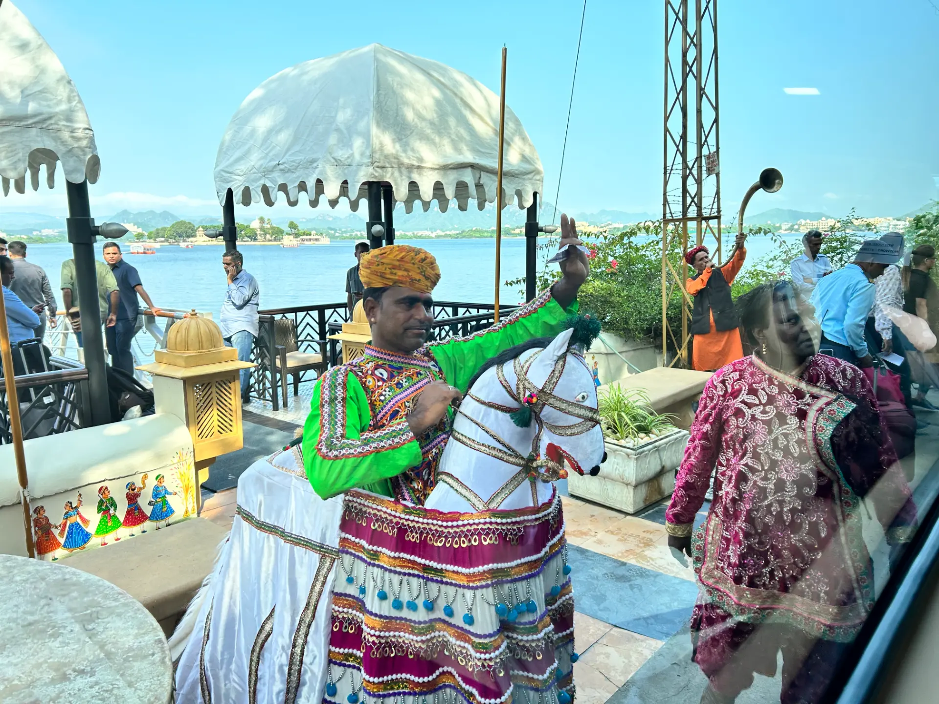 Traditional Rajasthani folk performers welcoming guests beside Lake Pichola in Udaipur
