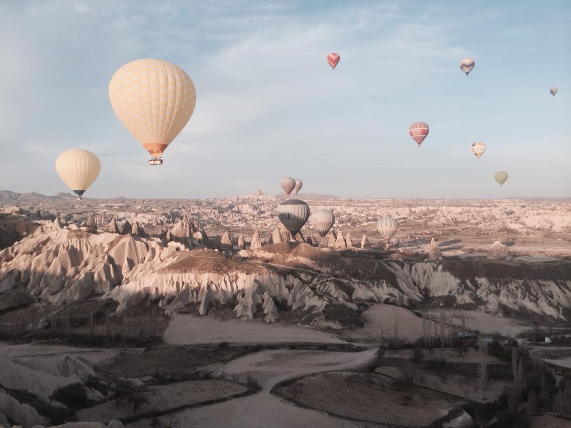 Hot air balloons rising above the fairy chimneys of Cappadocia, Turkey